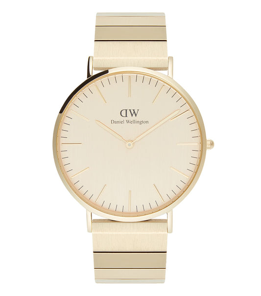 Daniel Wellington brushed gold piano watch at a 40-degree angle, showcasing sleek design and premium craftsmanship.