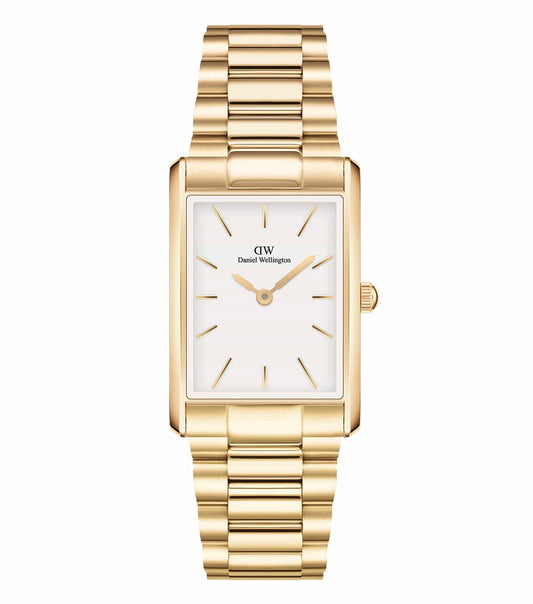 Daniel Wellington quartz watch in soft focus, elegant rectangular face, side profile view, showcasing gold-tone accents and classic design.