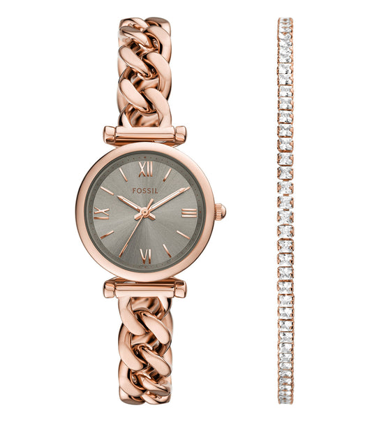 Fossil watch in polished gold tone, elegantly set face with Roman numerals, viewed from a slightly above angle.