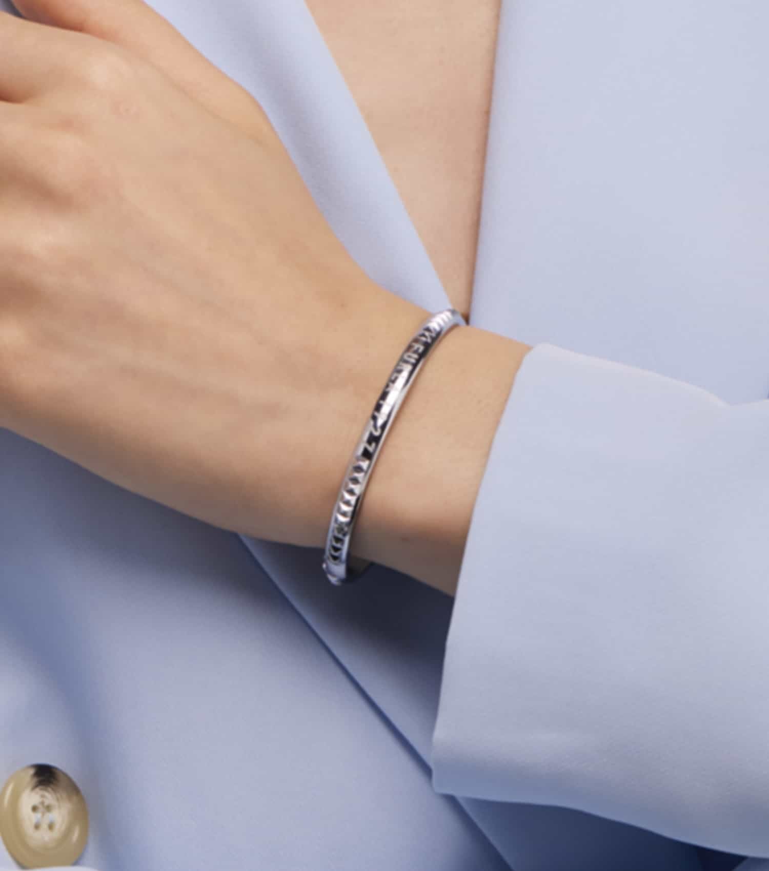 Furla gold bracelet with sleek design, angled top view showcasing intricate clasp details and elegant craftsmanship.