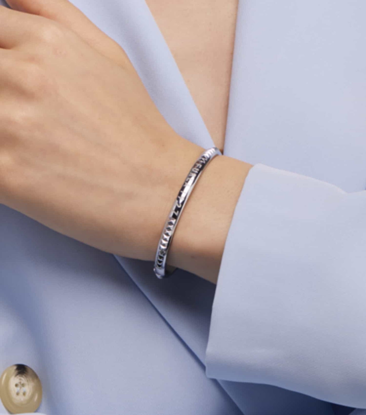 Furla gold bracelet with sleek design, angled top view showcasing intricate clasp details and elegant craftsmanship.
