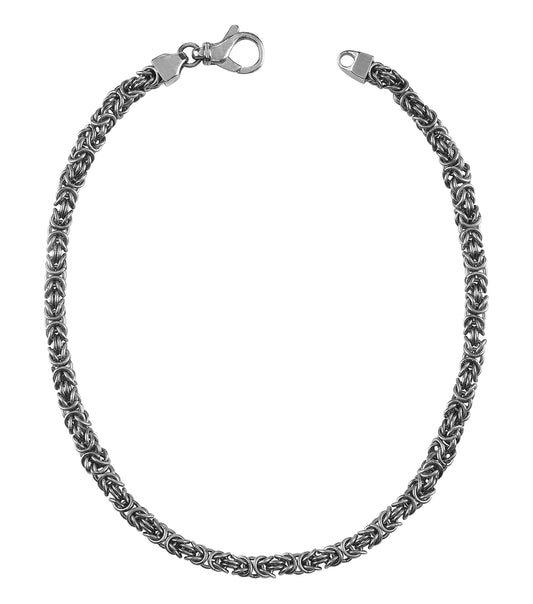 Guess Jewellery Antique Silver Necklace, elegantly displayed flat on a white surface, showcasing intricate chain details and craftsmanship.