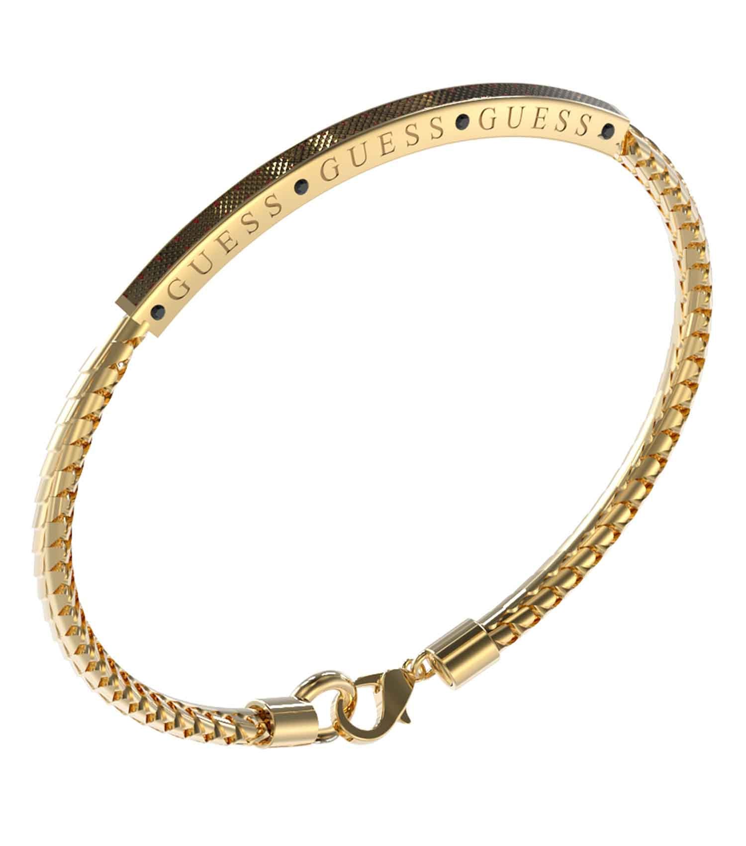 Gold and Black Guess Jewellery bracelet, showcasing its elegant design, captured at an angled top-down view on a sleek surface.