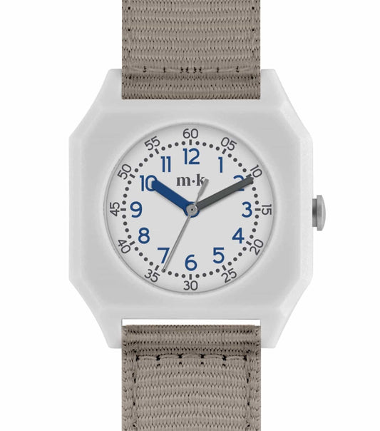 Bone-colored Mini Kyomo watch elegantly displayed at a tilted angle, featuring bold green numerals and a sleek design.