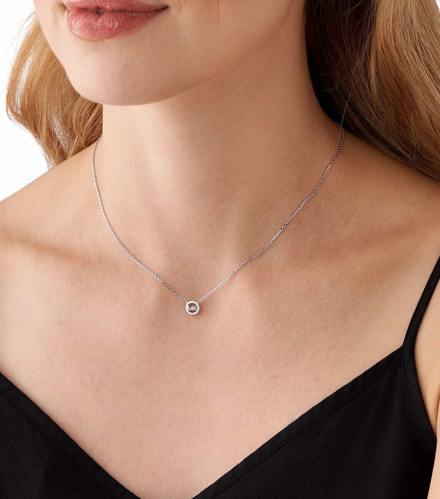 Michael Kors silver necklace, front view, showcasing elegant design with subtle charm; perfect accessory for fashion enthusiasts.