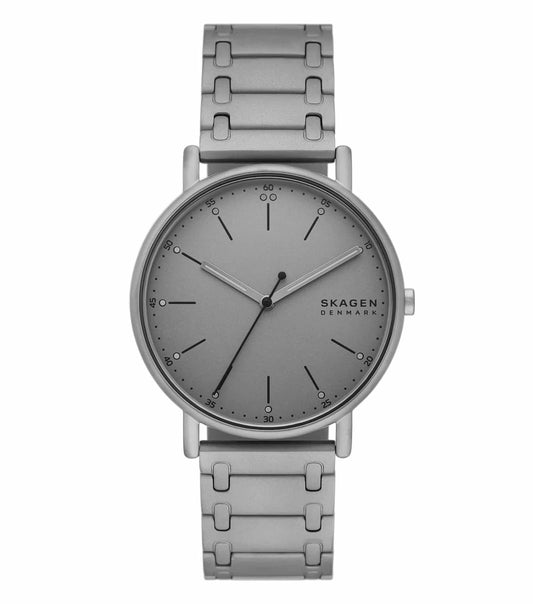 Skagen watch, grey color, angled upper-left view, showcasing its minimalist dial, silver mesh strap, and sleek design.